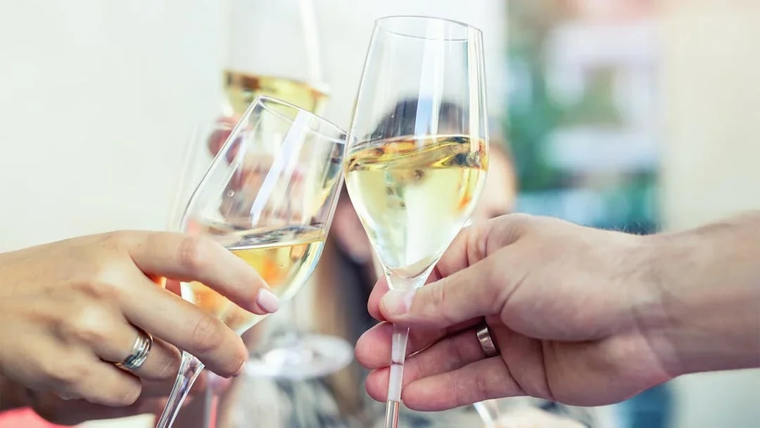Guests toasting with prosecco on Budapest evening cruise.
