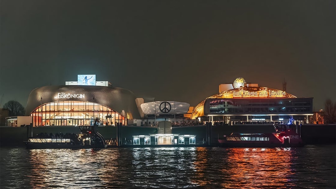 Grand Harbor evening view with illuminated theaters reflecting on the water.