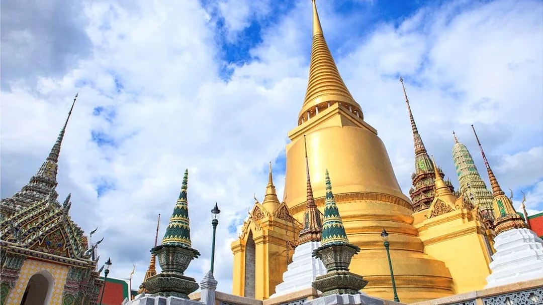 Golden stupa and ornate spires at Wat Phra Kaew, Bangkok, on a guided temple tour.