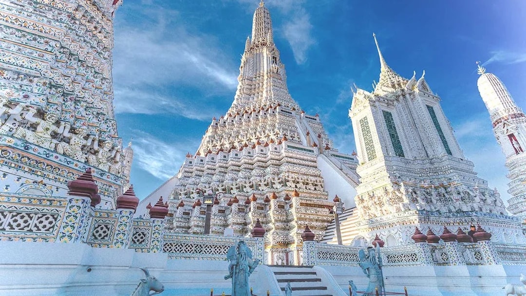 Wat Arun temple's ornate spires and intricate details in Bangkok, Thailand.