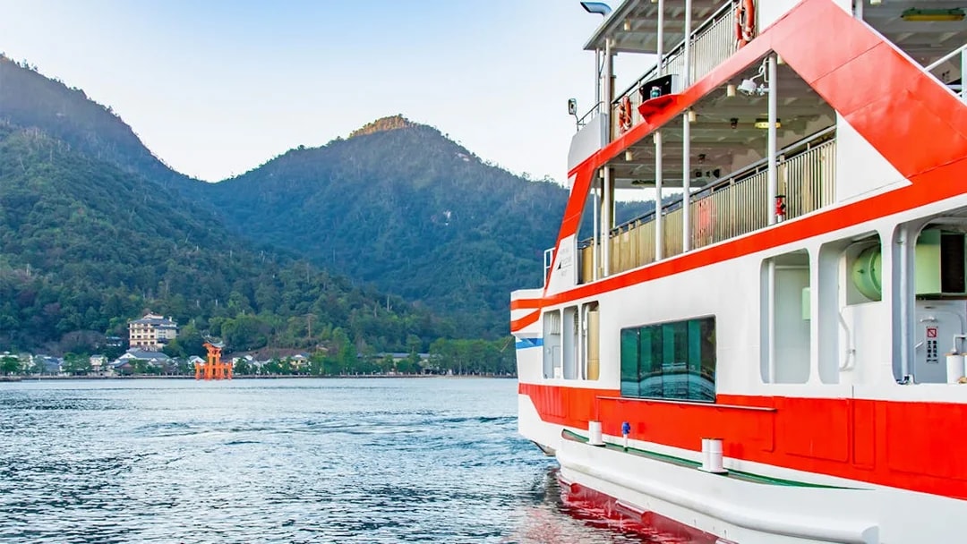 Ferry approaching Miyajima Island with view of Itsukushima Shrine's torii gate, Hiroshima.