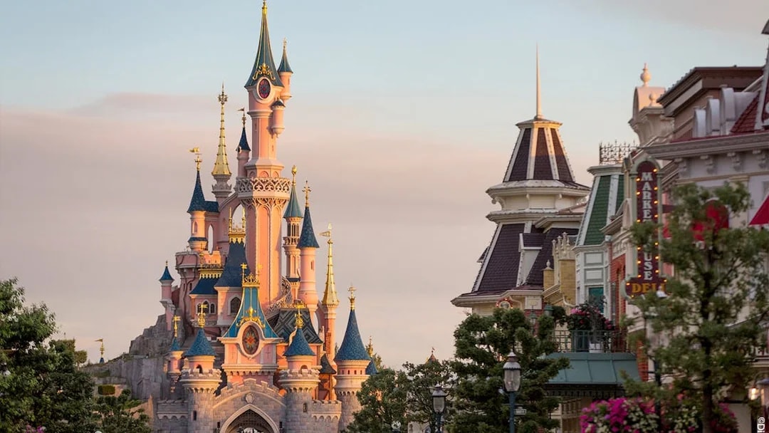 Sleeping Beauty Castle at Disneyland Paris with surrounding buildings.