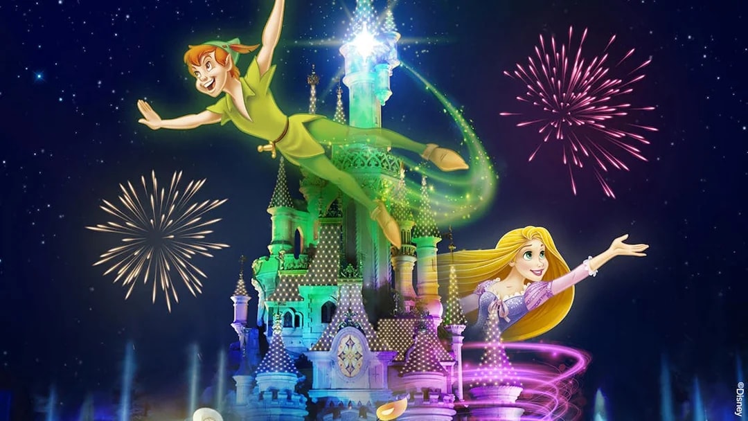 Fireworks over a castle with animated characters flying, Disneyland Paris.