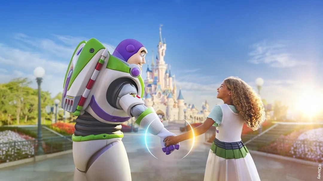 Buzz Lightyear holding hands with a child in front of Sleeping Beauty Castle at Disneyland Paris.