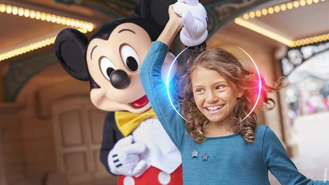Child enjoying Disneyland Paris with a character.