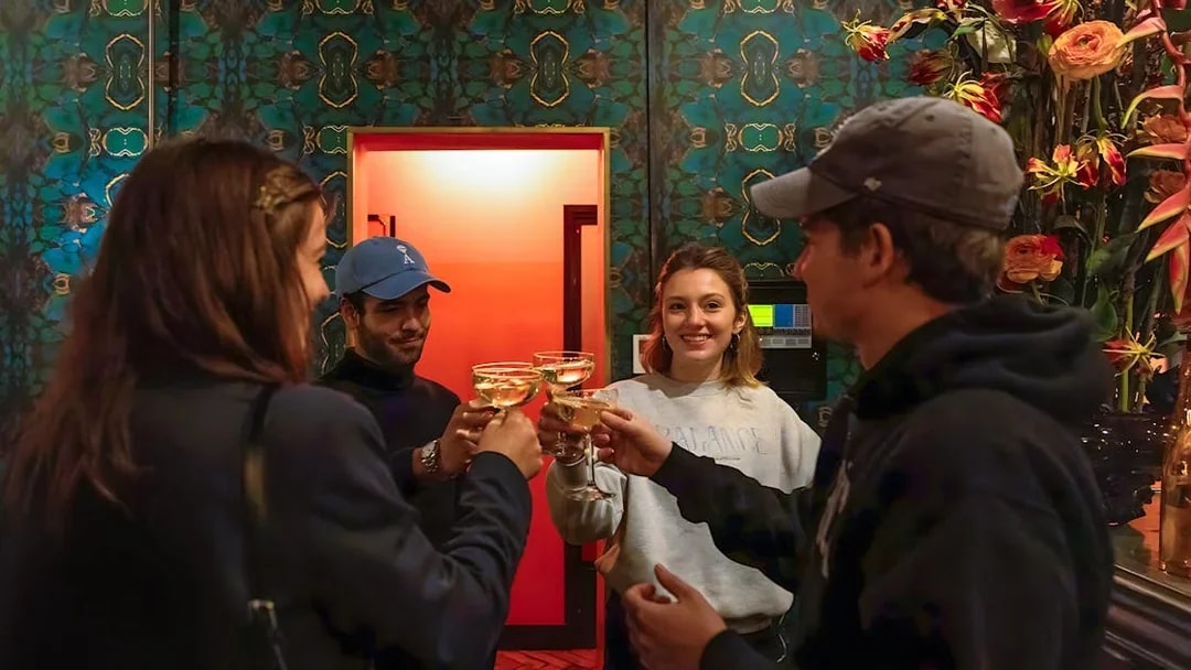 Visitors toasting at Tour de BonTon with floral decor in the background.