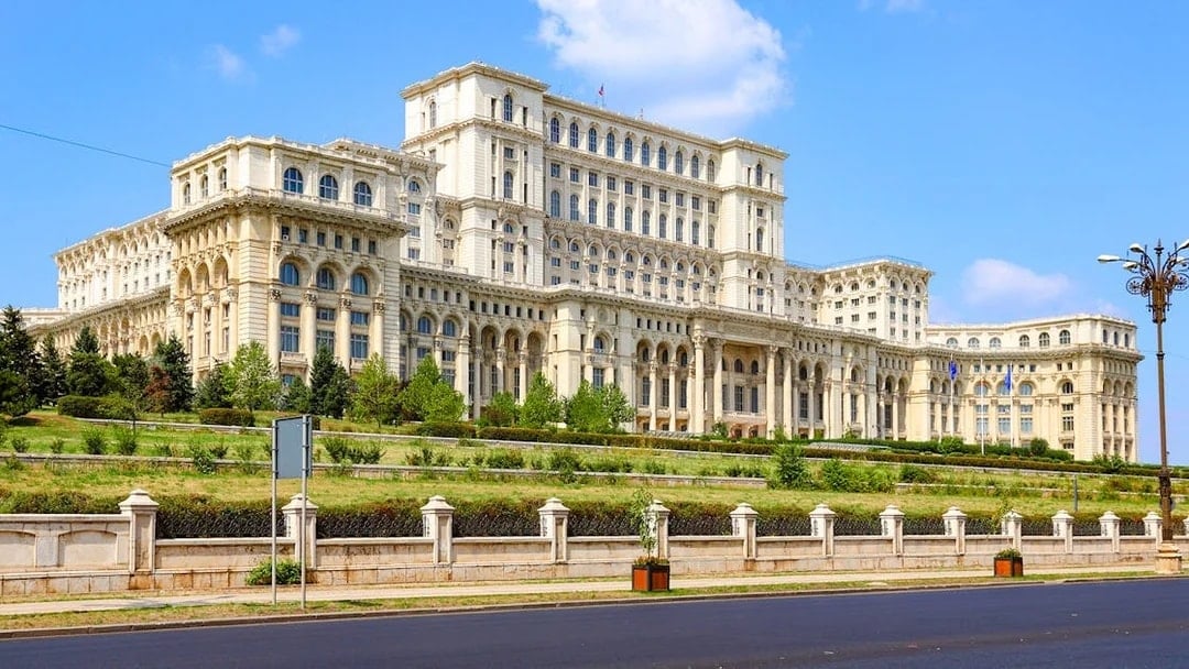 Bucharest Palace of the Parliament exterior with clear blue sky.