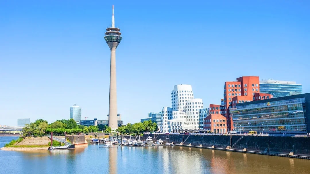 Rheinturm tower and modern buildings along the River Rhine in Dusseldorf.