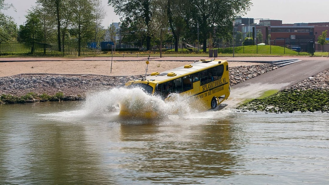 Amphibious bus entering water during 1-hour sightseeing tour in Rotterdam.