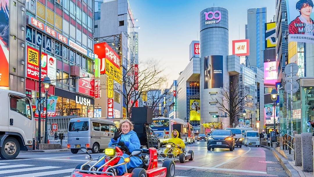Go-karting on a busy street in Shibuya, Tokyo at dusk.