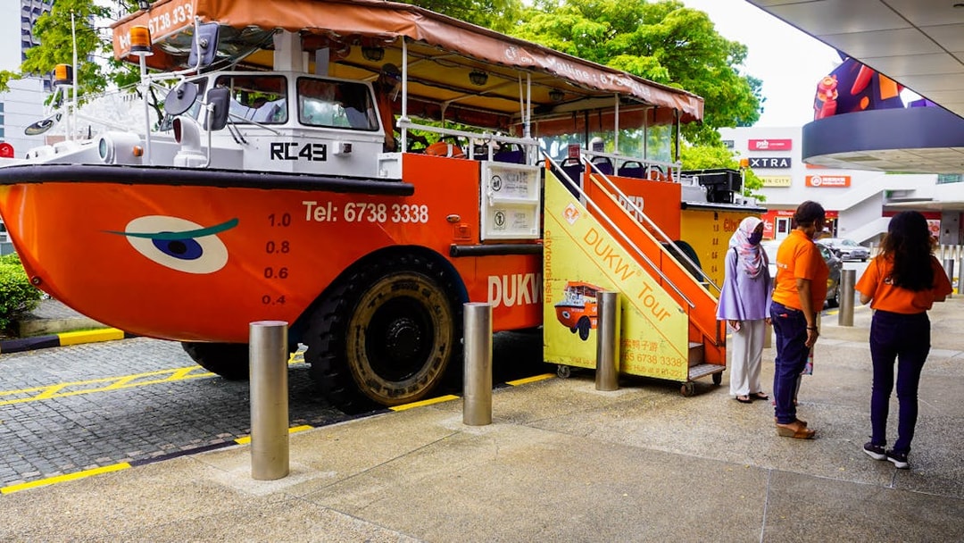 DUKW tour vehicle with passengers boarding in Singapore.