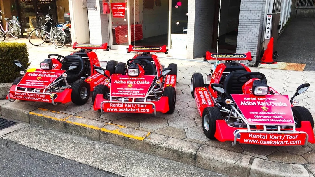 Go-karts parked outside Akiba Kart Osaka for street tour experience.