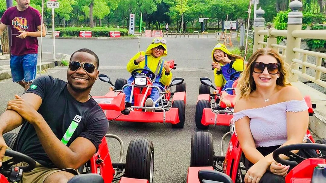 Participants enjoying Akiba Kart Osaka street go-karting in colorful costumes.