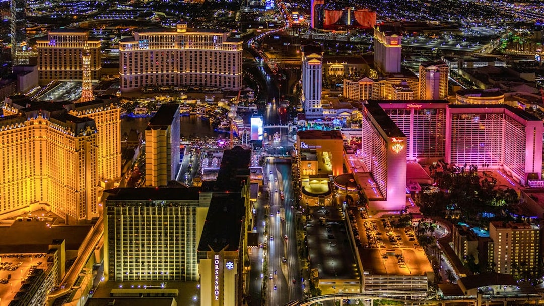 Aerial view of the Las Vegas Strip at night with illuminated hotels and casinos.