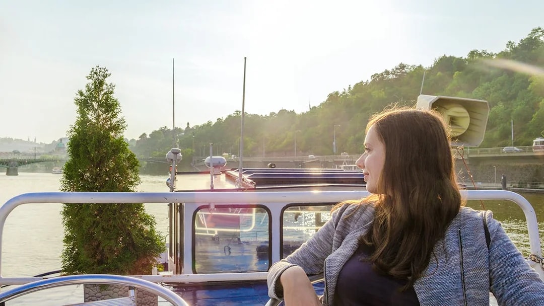 Person enjoying a scenic view on a Vltava River panoramic cruise.