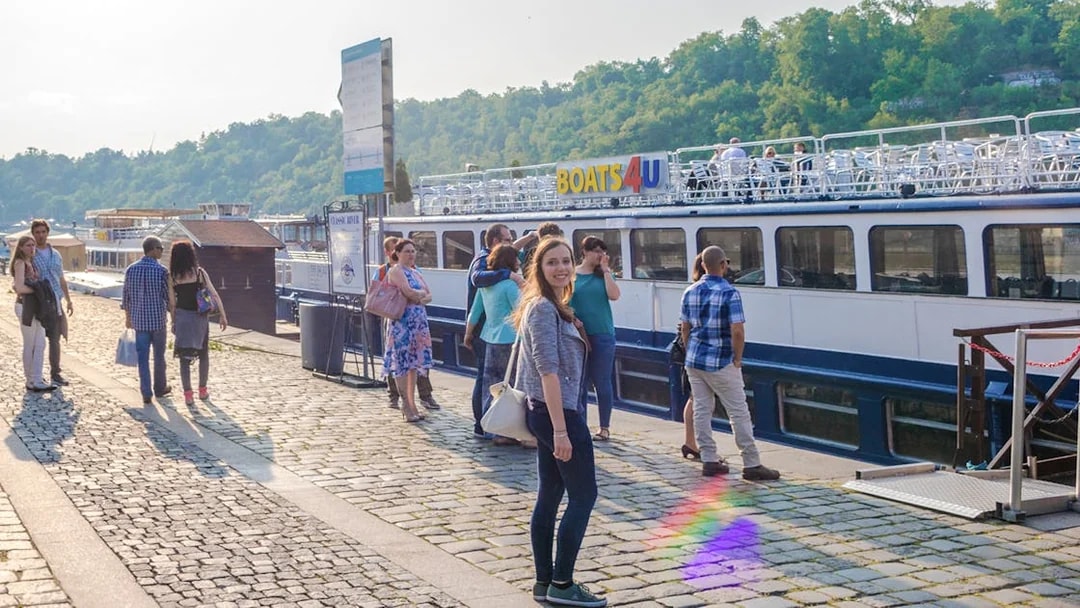 Tourists boarding a boat for a 1-hour panoramic cruise on the Vltava River.