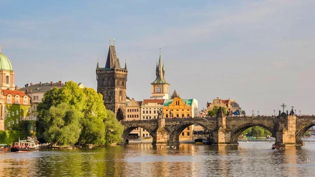 Charles Bridge over Vltava River with Prague's Old Town in the background.