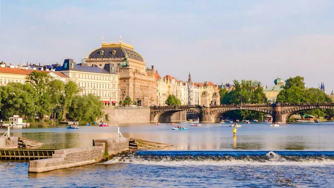 Prague's National Theatre and Vltava River during a sightseeing cruise.