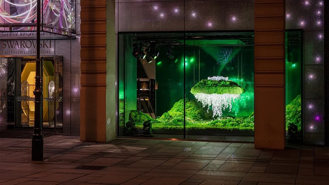 Swarovski House Vienna display with illuminated crystal installation and greenery.