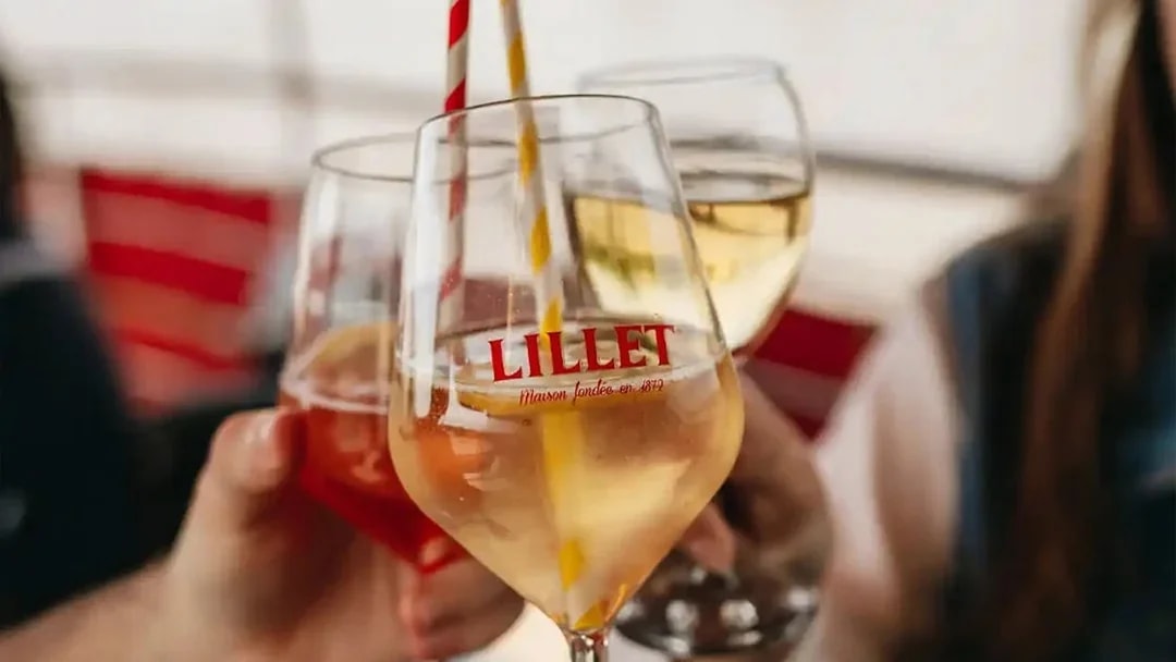 Glasses of Lillet being toasted on a Bordeaux River Cruise welcome event.