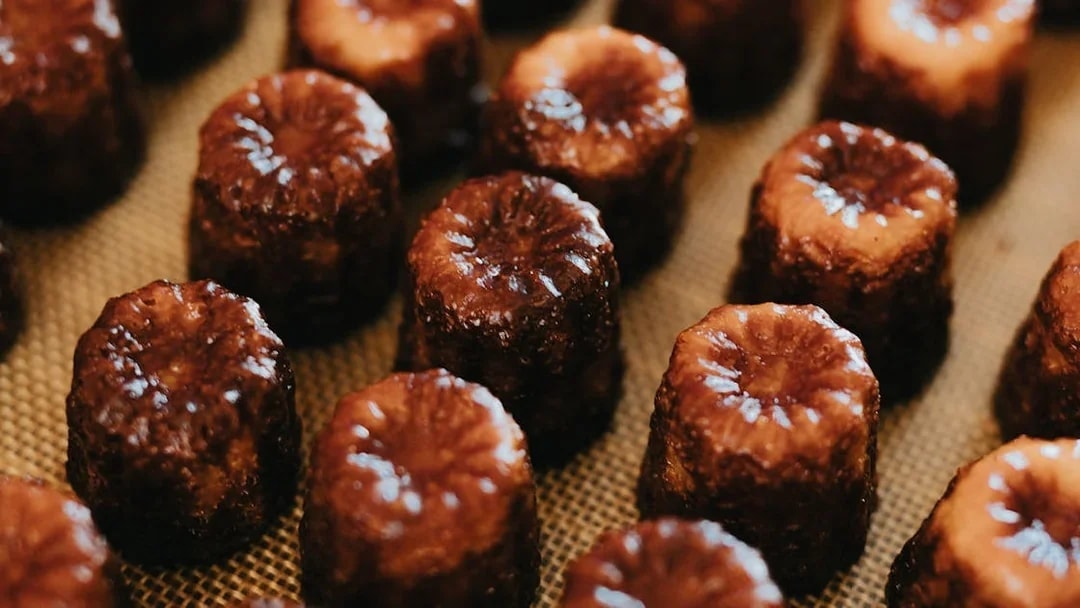 Canelés arranged on a tray for tasting on Bordeaux River Cruise.