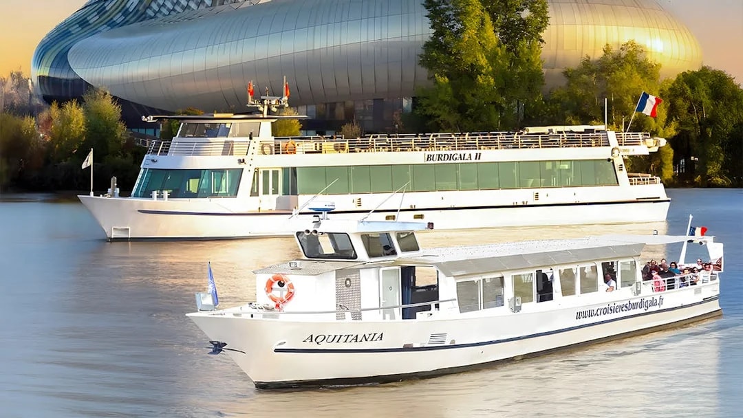 Cruise boats on the Garonne River near La Cité du Vin in Bordeaux, France.
