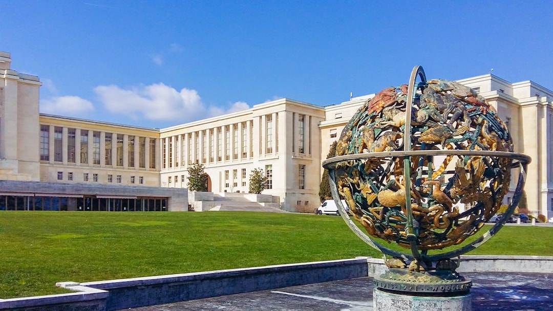 Palace of Nations in Geneva with Celestial Sphere sculpture in foreground.