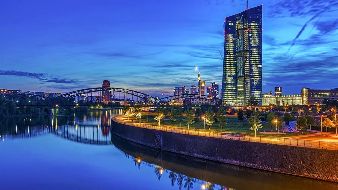 Frankfurt skyline at dusk with illuminated skyscrapers and river view during Evening Panorama Cruise.