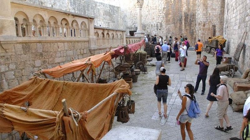 Tourists exploring Dubrovnik's historic walls on a Game of Thrones tour.