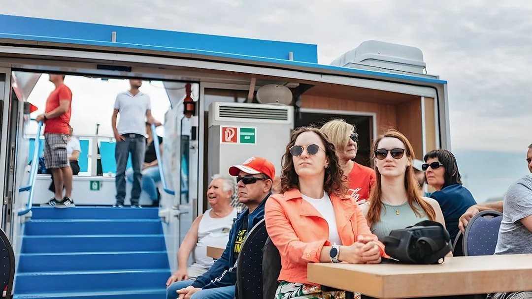 Passengers seated on a boat during the 2-Hour XXL Hamburg Harbor Cruise.