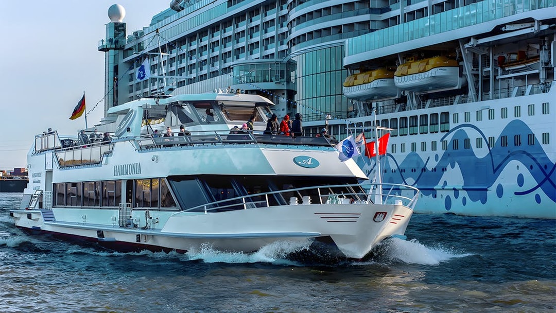 Cruise ship navigating Hamburg Harbor during 2-hour XXL tour.