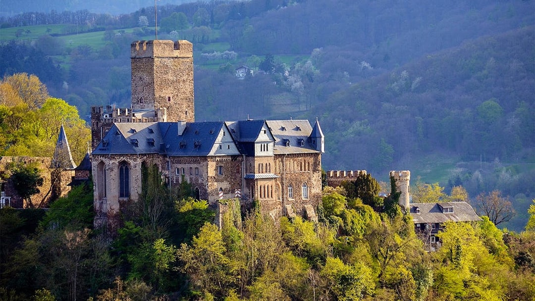 Marksburg Castle surrounded by lush greenery near Koblenz, Germany.