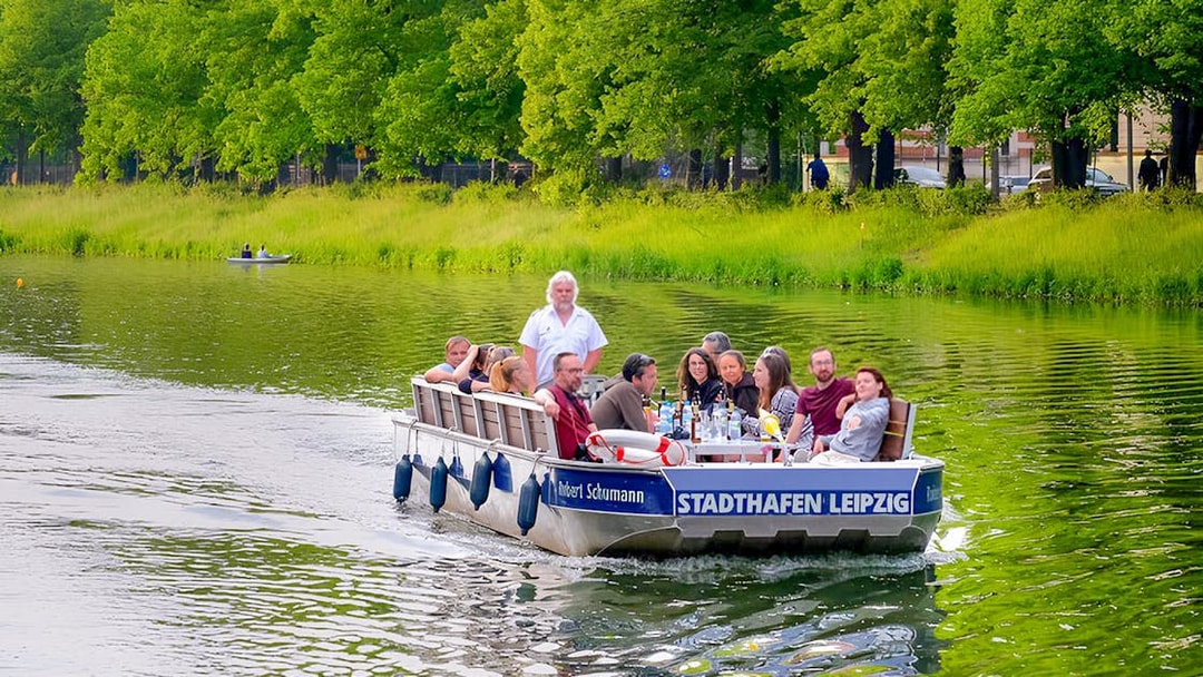 Guests on a motorboat tour in Auwald, Leipzig, enjoying the scenic river view.