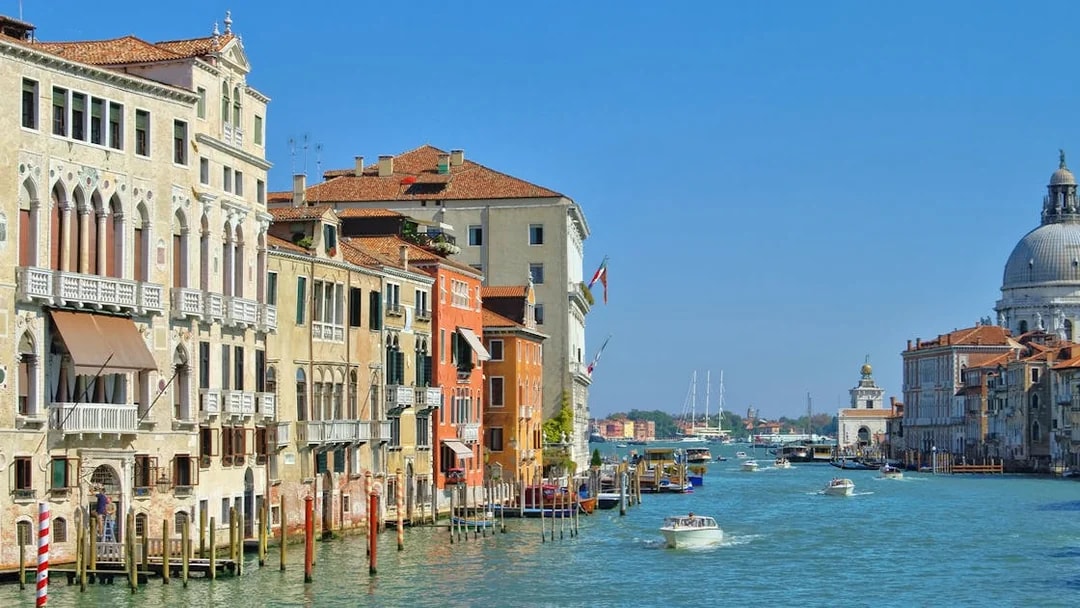 Venice Grand Canal with historic buildings and boats, featuring Santa Maria della Salute.