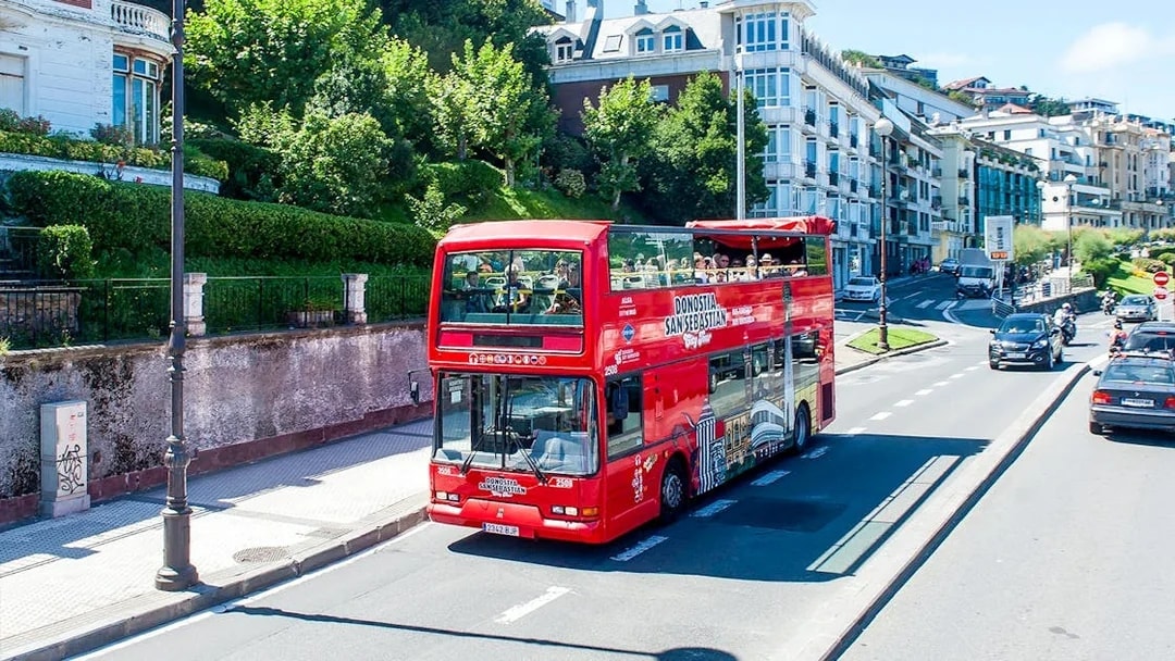 Red double-decker bus on San Sebastian city tour route.
