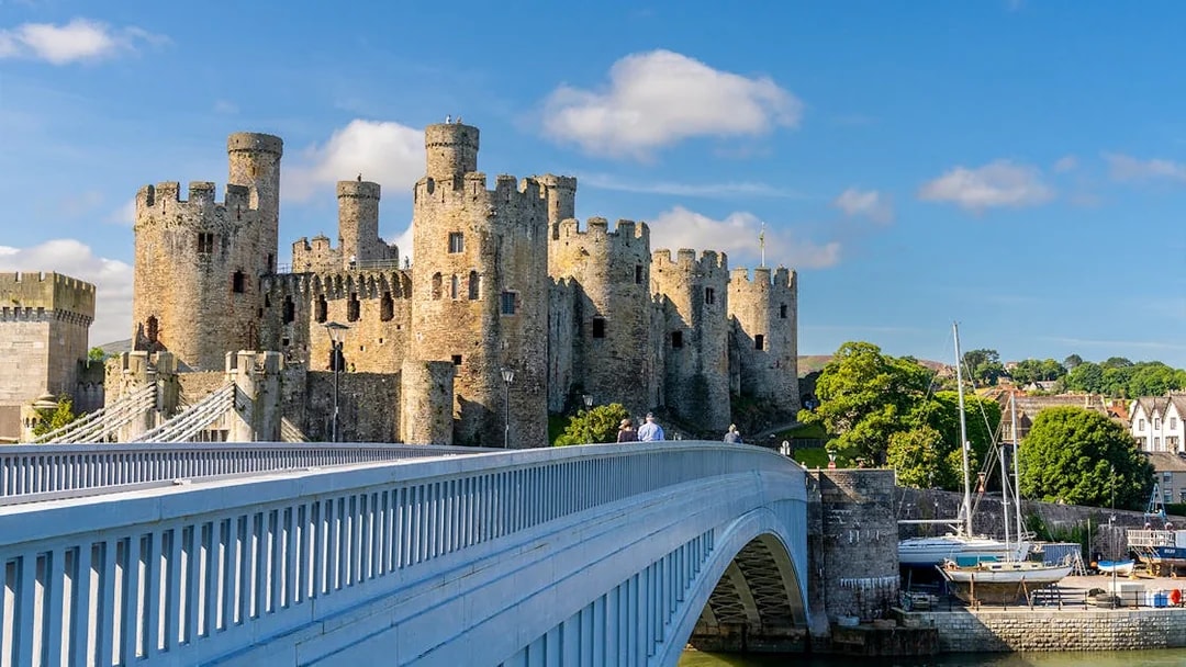 Conwy Castle with a bridge in Llandudno, part of the Hop-On Hop-Off Tour.