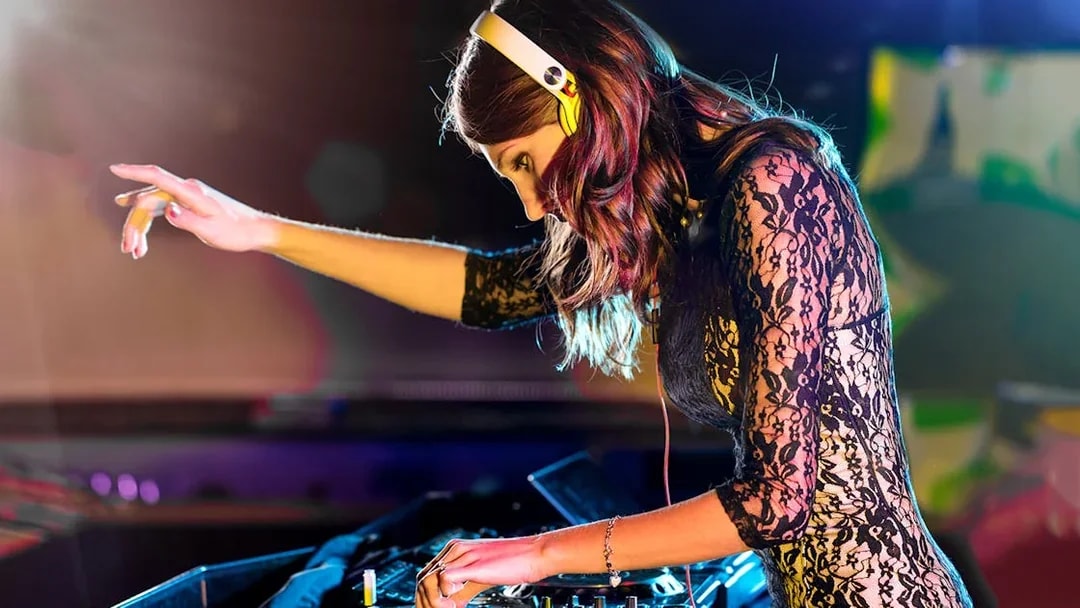 DJ performing on Evening Panorama Cruise with vibrant lights.