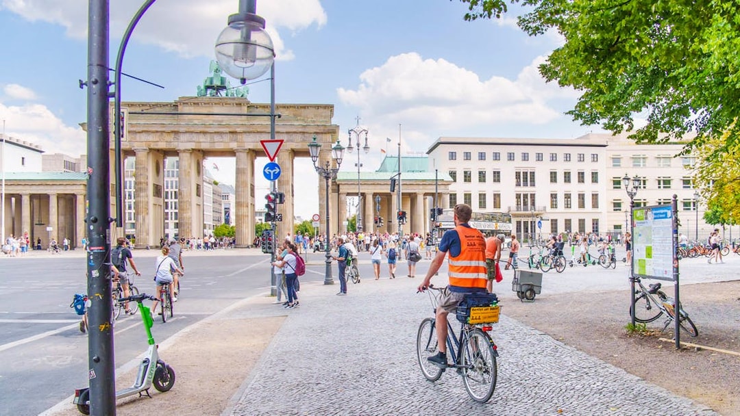 Cyclists near Brandenburg Gate on Berlin Wall bike tour.
