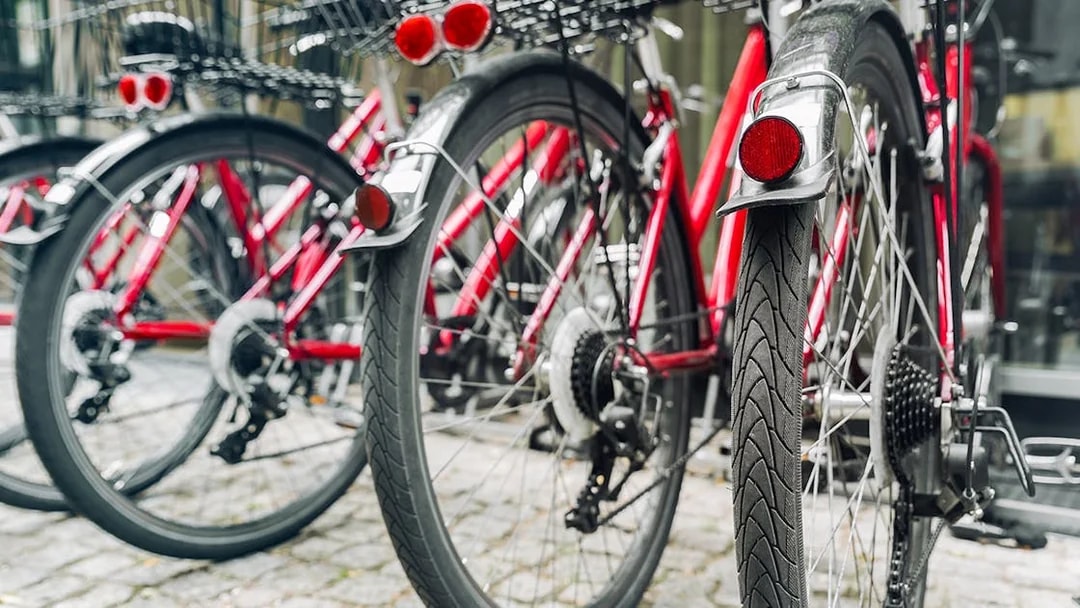 Red bicycles lined up for a guided bike tour in Germany.