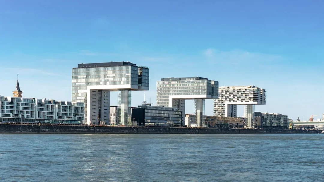 Kranhäuser buildings along the Rhine River in Cologne Harbour during the day.
