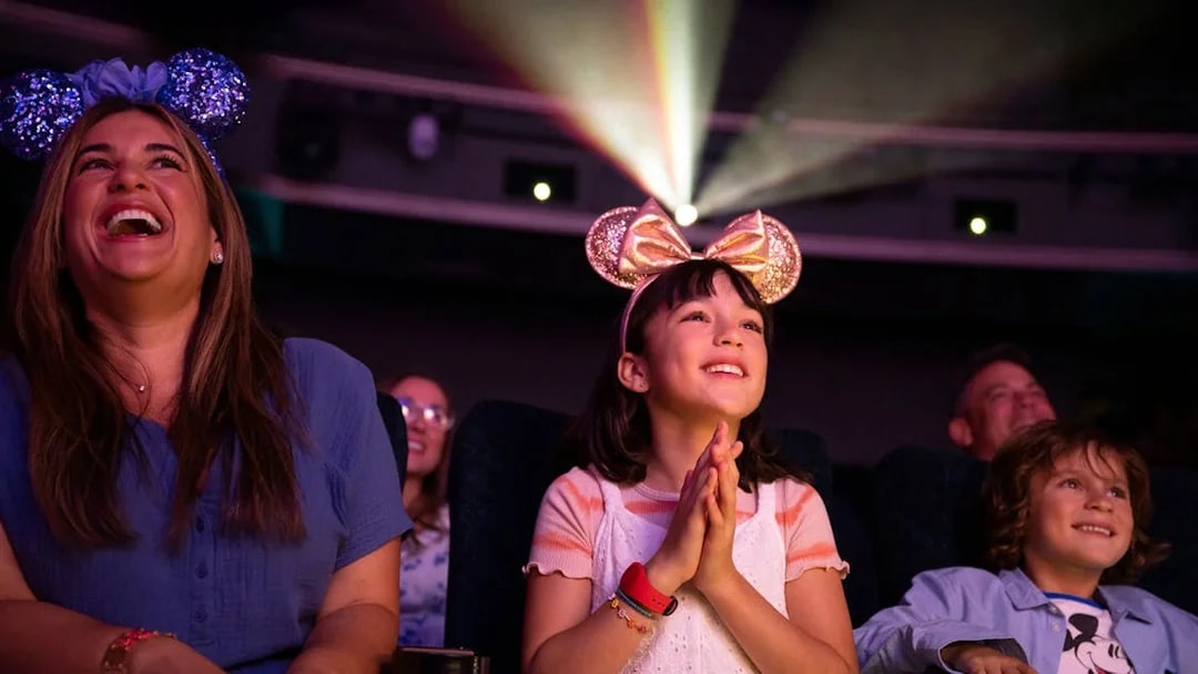People enjoying a movie screening on Disney Adventure Cruise.