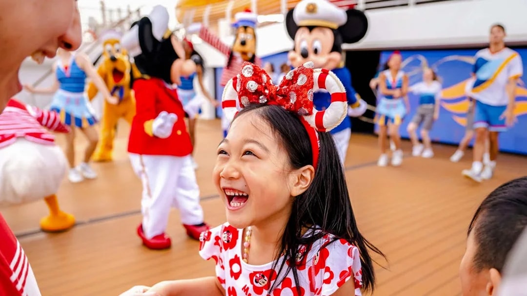 Child enjoying Disney characters on deck during 3-night cruise from Singapore.
