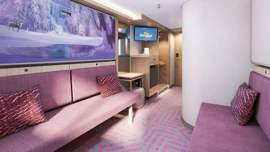 Inside stateroom with reef view on Disney Adventure Cruise, featuring purple seating and Frozen-themed artwork.