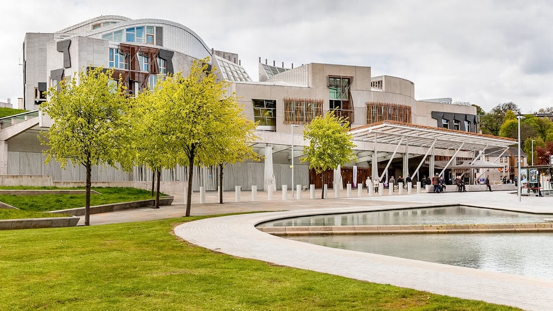 Scottish Parliament building in Edinburgh with modern architecture and surrounding greenery.