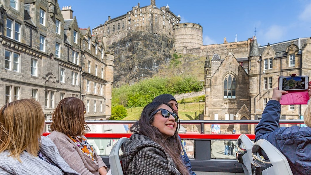 Tourists on HOHO bus near Edinburgh Castle, Scotland.