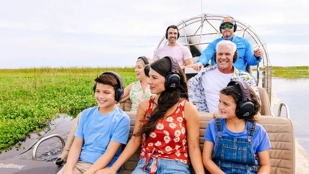 Guests listening to guide during Everglades Airboat Tour.