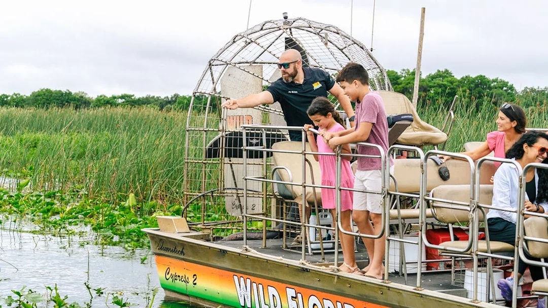Guests on an airboat tour enjoying the Everglades view in Florida.