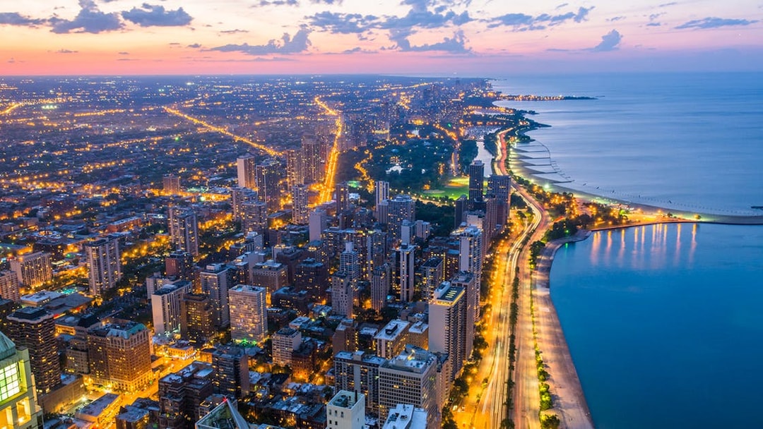 Chicago skyline and Lake Michigan view from 360 Observation Deck at sunset.