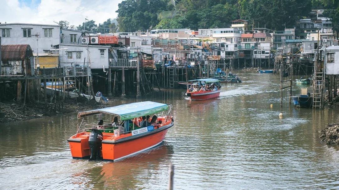Boats navigating the stilt houses of Tai O fishing village, Hong Kong.