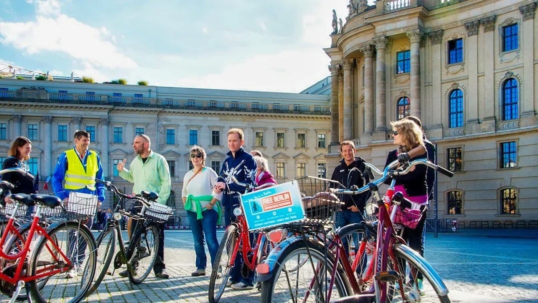 Group on a guided bike tour in front of Berlin's historic Humboldt University.